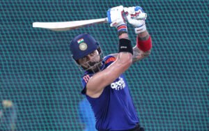 Virat Kohli signs autogrh on net bowler's India jersey at Brabourne Stadium